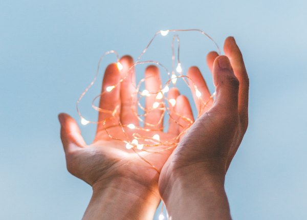 Open hands holding lights