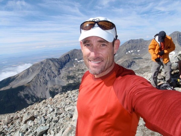 David Boyd on top of a mountain, smiling