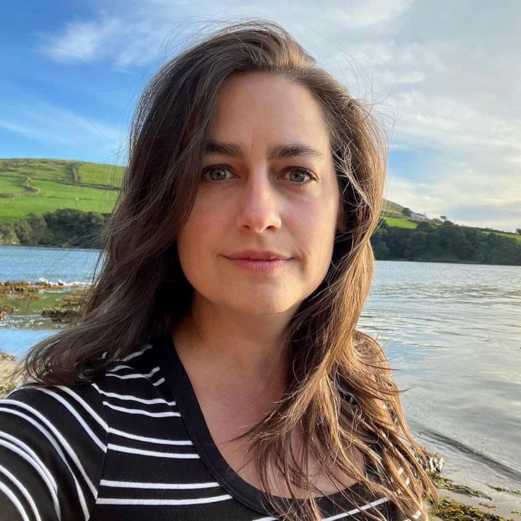 Anne Pinkerton facing camera next to Dingle Bay